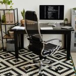 Image of modern workplace of programmer with chair and with computer on the table