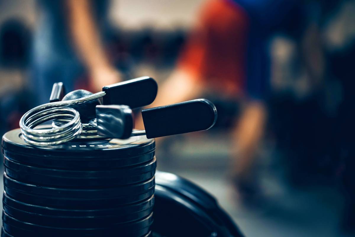 Crossfit equipment. Expander and barbell weight plates close up. Modern gym