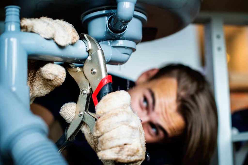 Man fixing kitchen sink