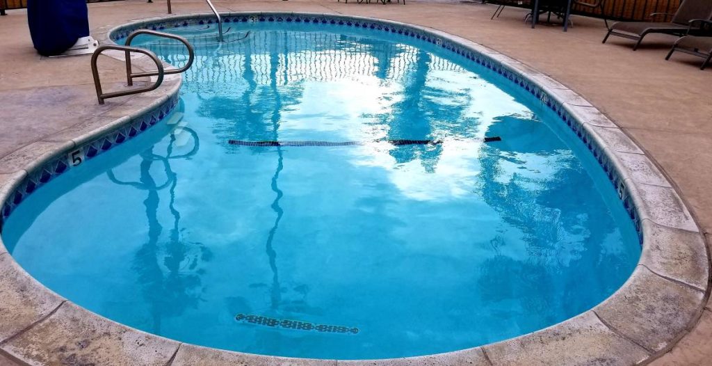 How do I know if my concrete pool needs resurfacing? How much does it cost to resurface concrete around a pool?