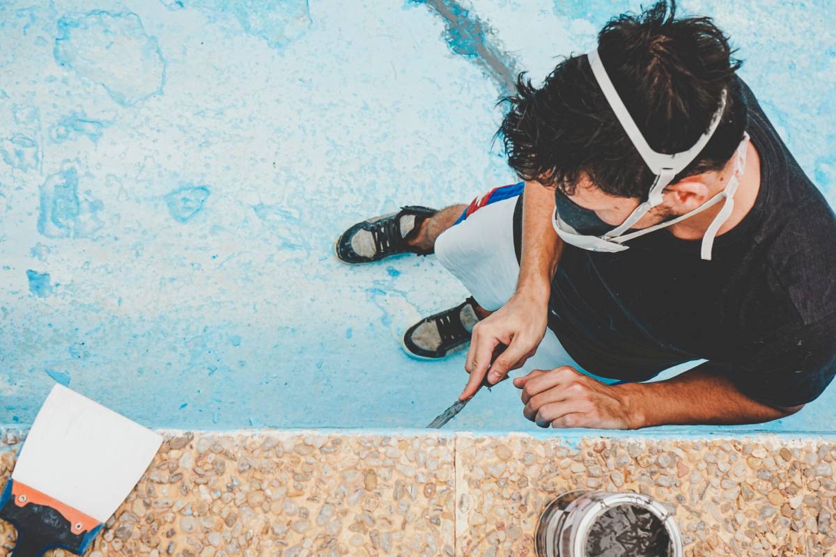 Young man working in his swimming pool