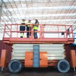 Low angle view of site managers and architect on viewing platform on construction site