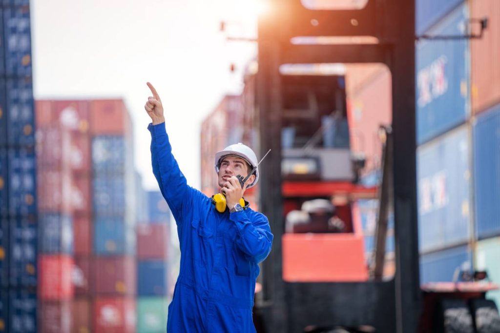 Container yard worker checking container at container yard warehouse,Logistics transportation and shipping business concepts.